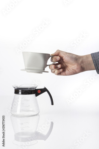 woman hand a coffee port for hand drip coffee isolated white. photo