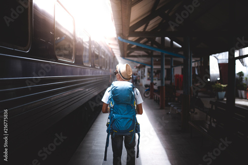 Traveler are backpacking and walking alone at train station.