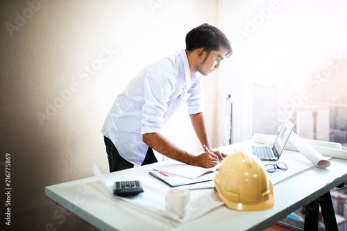 Architect working on blueprint.engineer inspective in workplace - architectural project photo