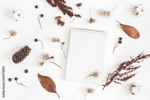 Autumn composition. Notebook, acorns, pine cones, dried flowers and leaves on white background. Autumn, fall concept. Flat lay, top view, copy space