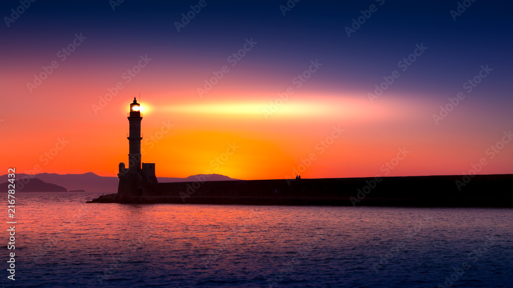 A beautiful night sky behind a shining lighthouse. Chania, Crete, Greece
