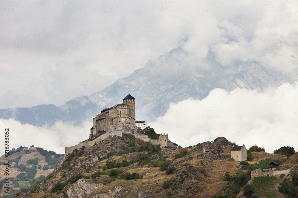 castle and church on hill above swiss town of sion in the rhone valley