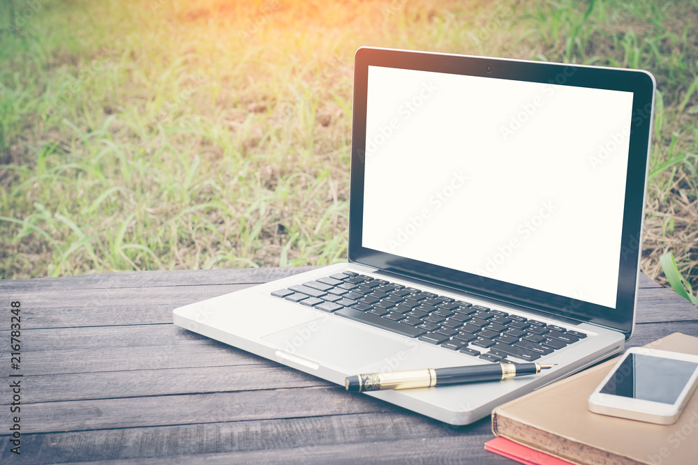 Laptop with blank screen on wood table, outdoor office. Travel concept. Business ideas. Choice of travel. Copy space. Online store. Laptop with blank screen on wood table, outdoor office. Travel concept. Business ideas. Choice of travel. Copy space. Online store.