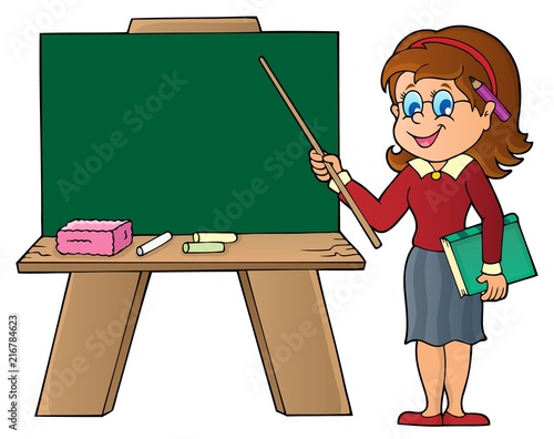 Woman teacher standing by schoolboard