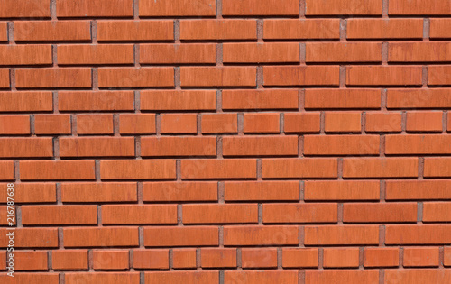 Brick wall of red color, wide panorama of masonry.