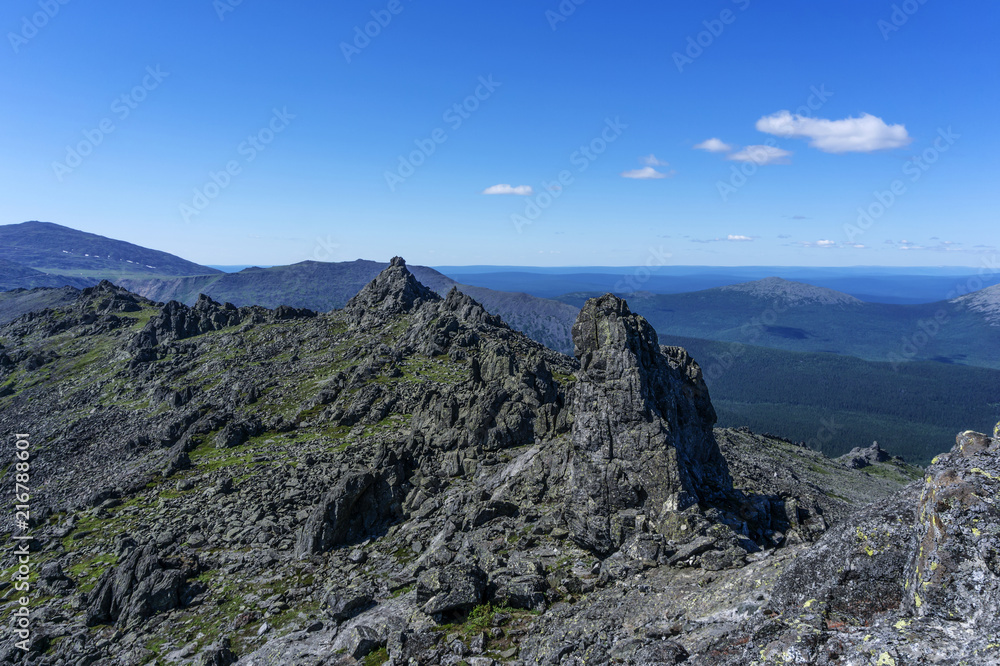 beautiful mountain landscape with spectacular black rocks in a blue atmospheric haze in the vicinity of mount Konzhakovskiy Kamen