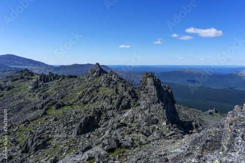beautiful mountain landscape with spectacular black rocks in a blue atmospheric haze in the vicinity of mount Konzhakovskiy Kamen © Evgeny