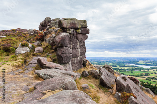 Rock formations at the Roaches, Peak District National park, view of the stones and fields on the background, selective focus