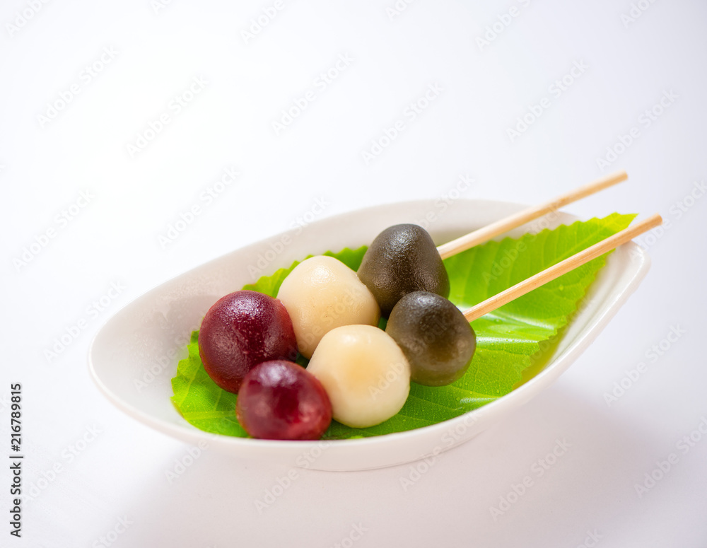 Japanese Dango dessert with 3 different color in pink(red), white, and green, recipe, hanami Dango, tsukimi Dango, copy space. Japanese Dango dessert with 3 different color in pink(red), white, and green, recipe, hanami Dango, tsukimi Dango, copy space.