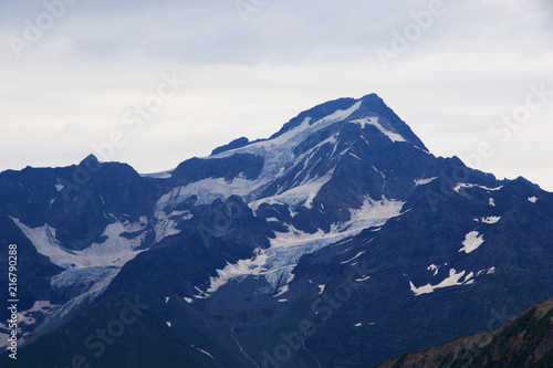 snow on the peak, mountain landscape, cloudy weather, Georgia. Alpine zone, place for hiking.