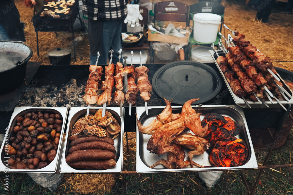 Homemade sausage. Barbecue. Pickles and salads. Festival of street food and  meat bbq. Festival of street food and meat. Photos | Adobe Stock