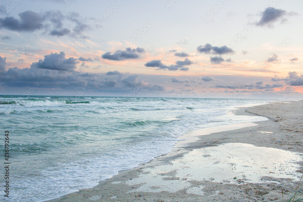 Empty sea coast beach landscape with sunrise cloudy sky