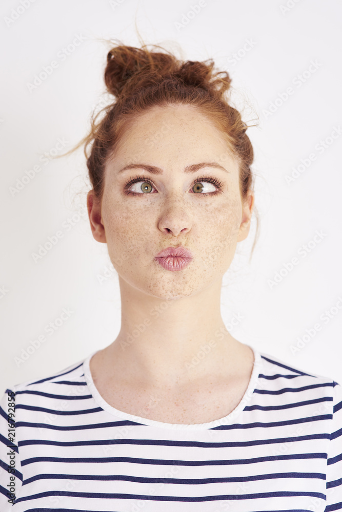 Cross eyed girl making a face at studio shot Cross eyed girl making a face at studio shot