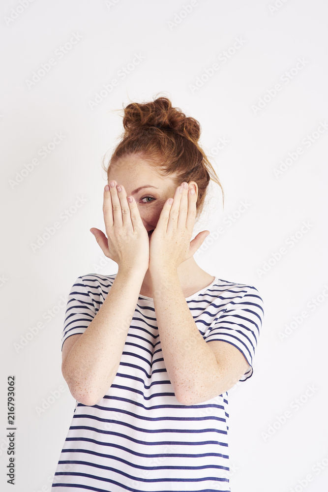 Portrait of shy woman covering face with hands at studio shot Portrait of shy woman covering face with hands at studio shot