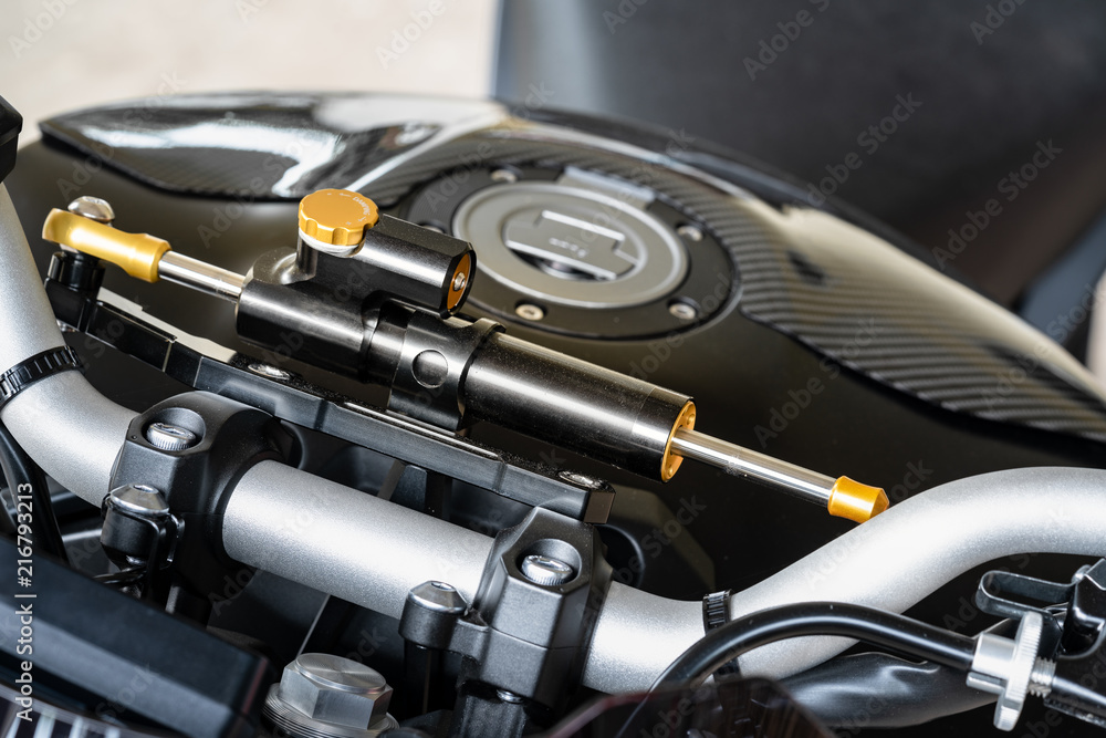 Motorcycle steering damper.
A damper helps keep the bike tracking straight over difficult terrain such as ruts, rocks, and sand, and also smooths out jolts through the handlebars at the end of jumps.