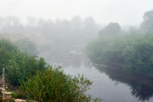 Fototapeta Naklejka Na Ścianę i Meble -  Fog over the river early in the morning.