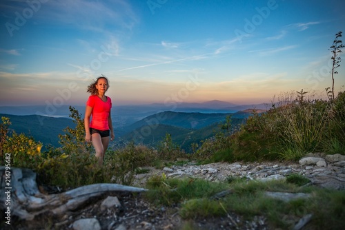 Young beautiful woman on mountain trail