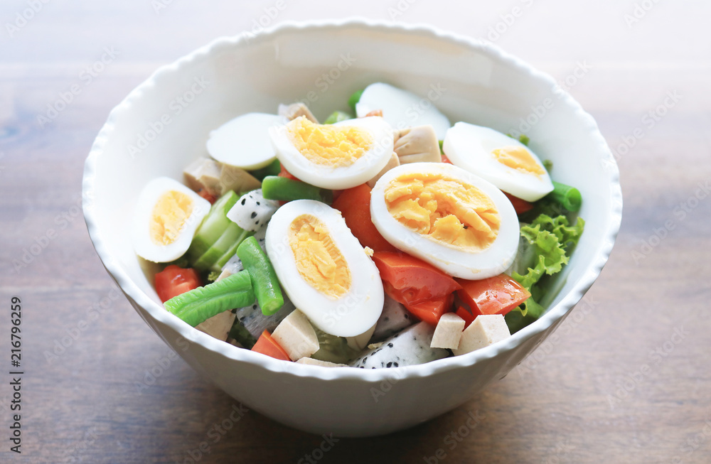 Diet menu. Healthy salad of fresh vegetables and egg on a bowl Diet menu. Healthy salad of fresh vegetables and egg on a bowl