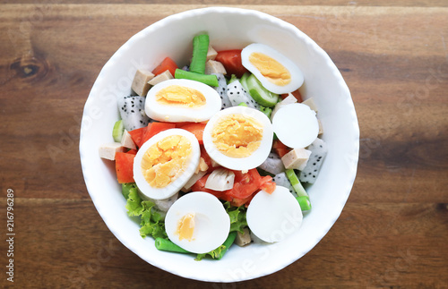 Diet menu. Healthy salad of fresh vegetables and egg on a bowl