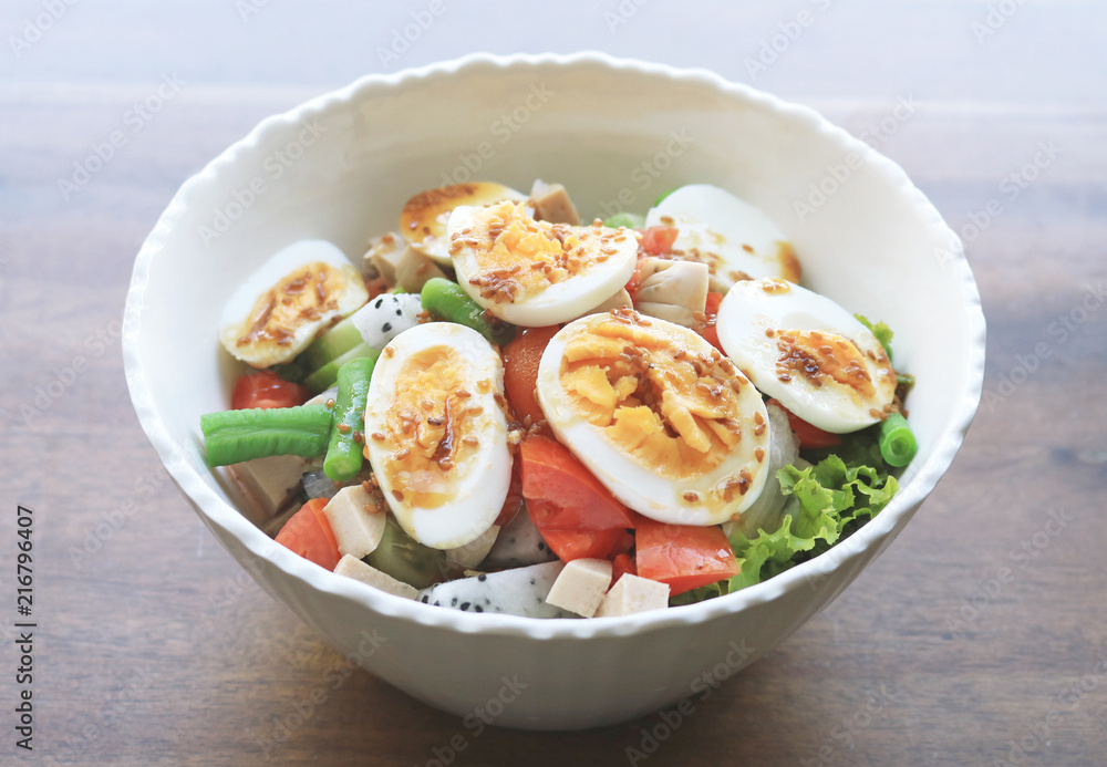 Diet menu. Healthy salad of fresh vegetables and egg on a bowl Diet menu. Healthy salad of fresh vegetables and egg on a bowl