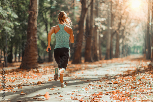Obraz na płótnie Woman Jogging Outdoors in The Fall