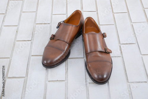 Set of Luxury leather men's shoes on white brick wall