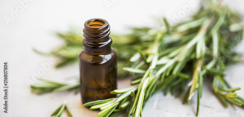 Herbal green rosemary herb essential oil bottle, selective focus