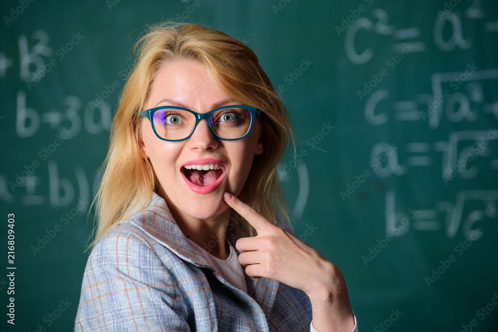 Teacher wonder about result. Do you know how solve that task. Woman wear eyeglasses smart teacher classroom chalkboard background, close up. School education basic knowledge. Solve mathematics task Teacher wonder about result. Do you know how solve that task. Woman wear eyeglasses smart teacher classroom chalkboard background, close up. School education basic knowledge. Solve mathematics task