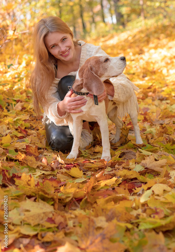 Beautiful girl with dog in the park. © Igor Normann