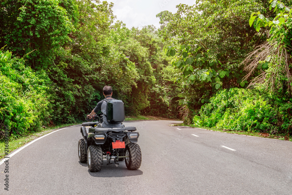 Man on atv bike adventure in forest Man on atv bike adventure in forest