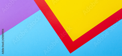 Color papers geometry flat composition background with yellow red violet and blue tones