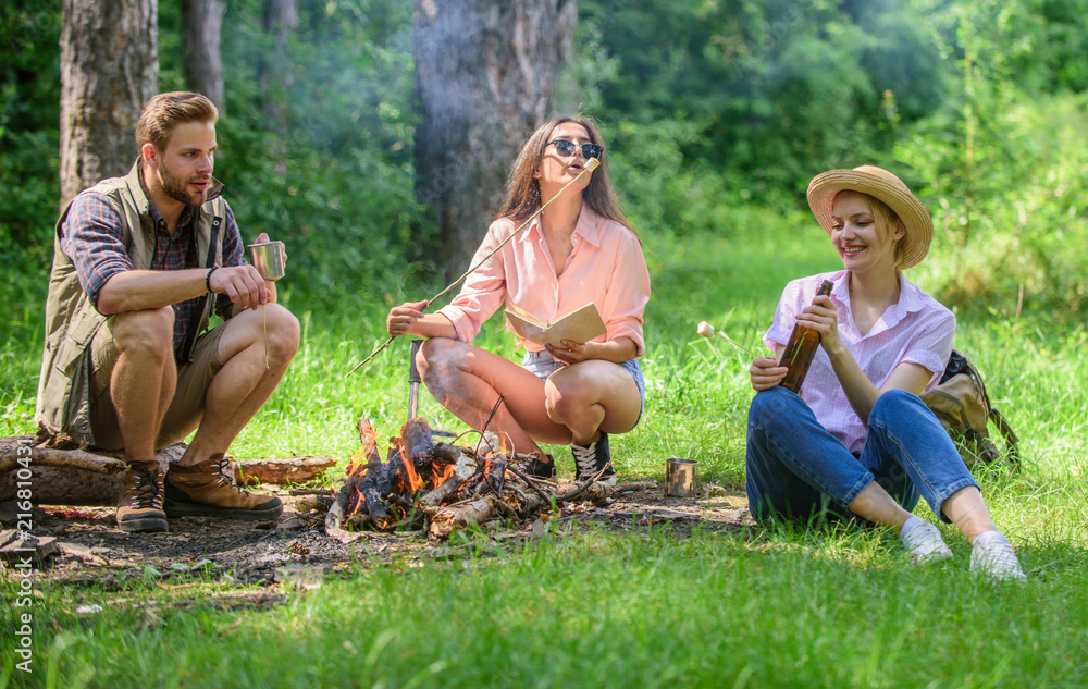 Take a break to have snack. Company hikers at picnic roasting marshmallows snacks. Company friends prepare roasted marshmallows snack nature background. Spend great time on weekend. Hikers traditions