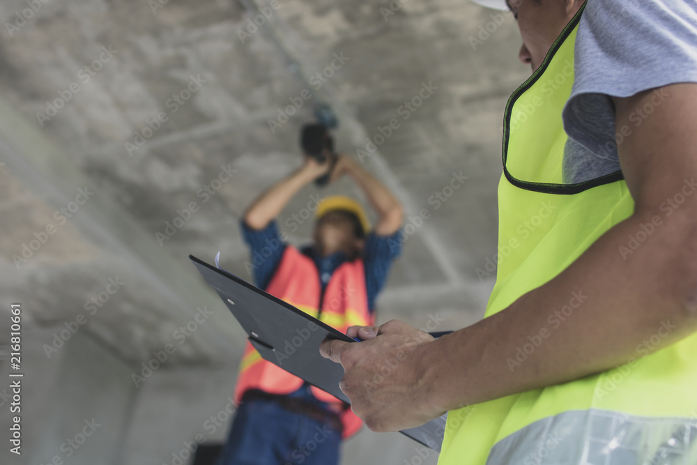 inspector checking worker working in construction site inspector checking worker working in construction site