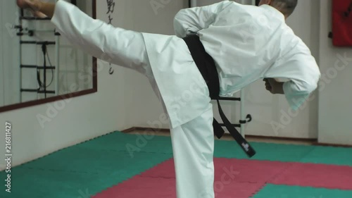 Young man with muscled body, training martial arts Goju-Ryu Karate-Do