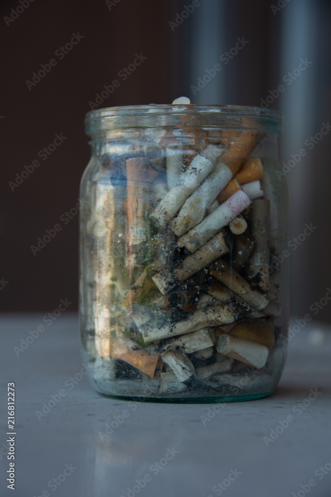 Smoked cigarette buns in a glass jar Smoked cigarette buns in a glass jar
