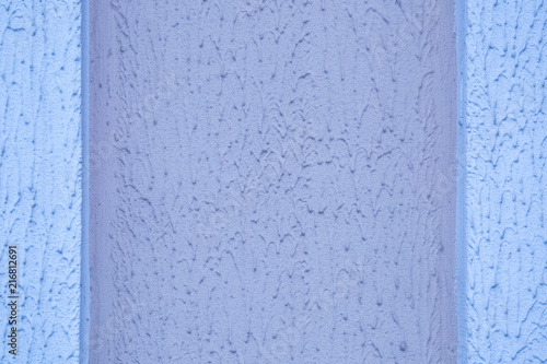 abstract background: Decorative plaster with a rough surface, painted with outdoor paint in blue and purple color