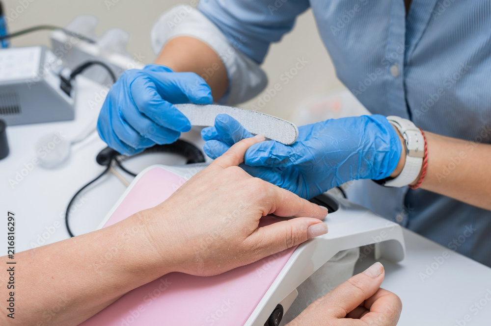 Manicure, nail extensions, the master paints nails Manicure, nail extensions, the master paints nails