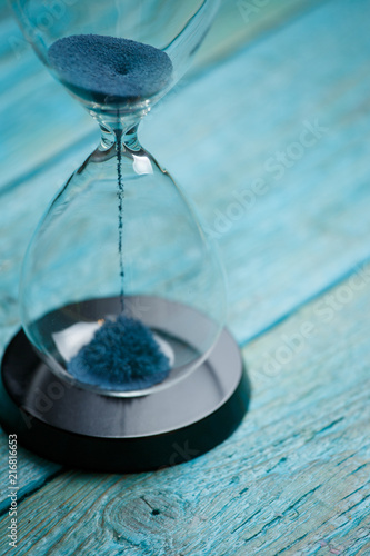 Photo of hourglass with blue sand © Sergey