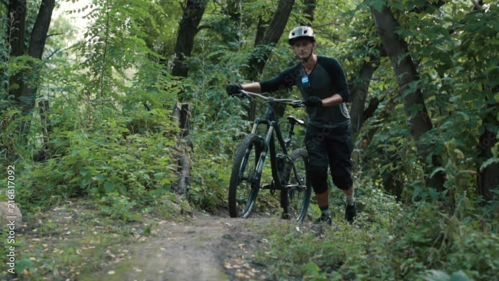 extreme cyclist comes with bicycle in forest extreme cyclist comes with bicycle in forest