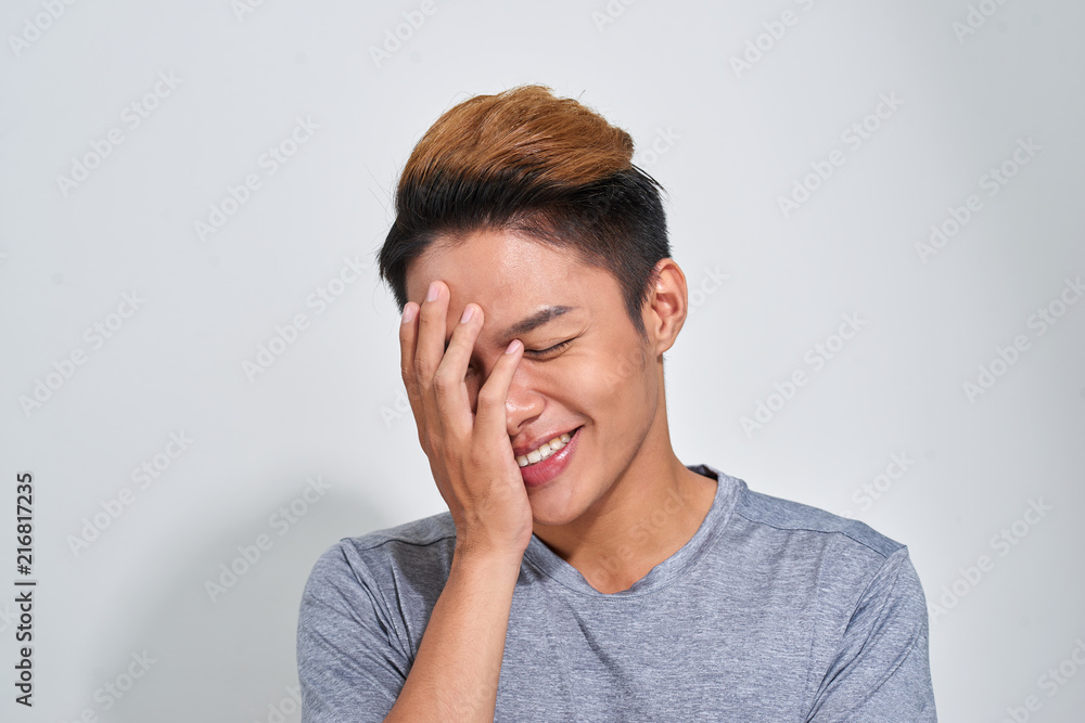 Portrait of smiling happy sport man wearing t-shirt over gray studio background Portrait of smiling happy sport man wearing t-shirt over gray studio background