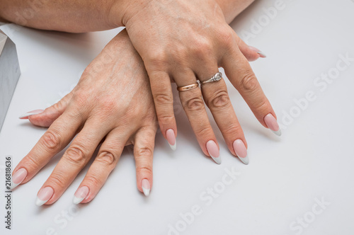 Beautiful manicure, women's hands, handbag