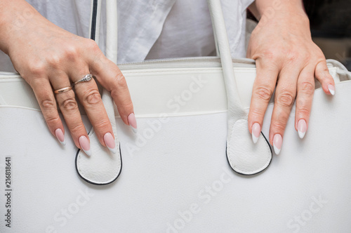 Beautiful manicure, women's hands, handbag