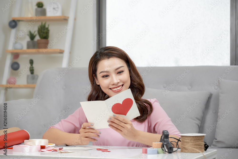 Valentine day theme. Beautiful romantic woman making present for her couple Valentine day theme. Beautiful romantic woman making present for her couple