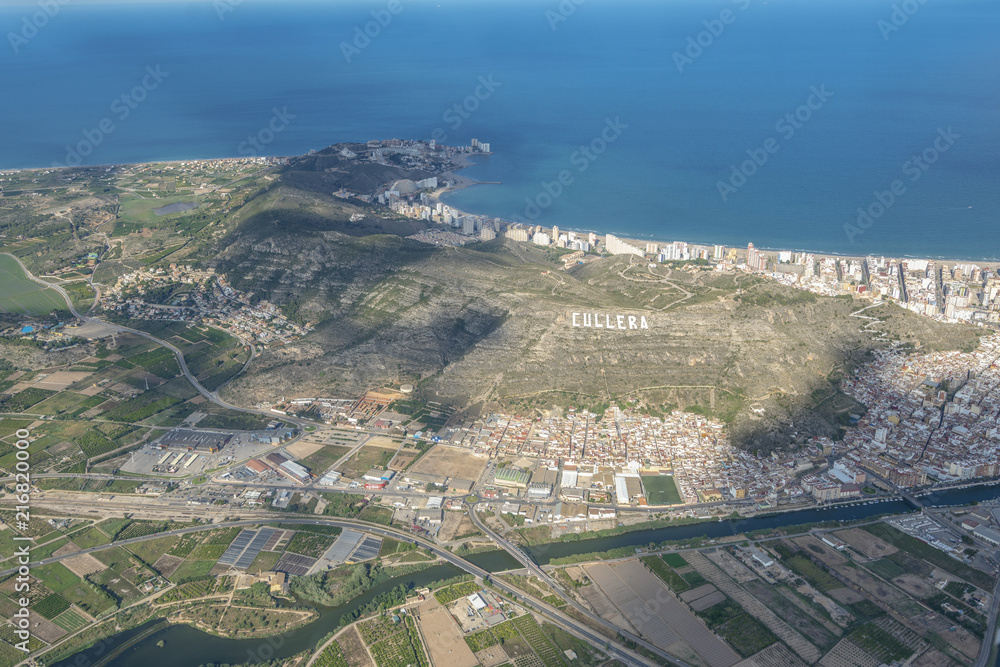 Areal view from airplane of Cullera resort village in Valencia region.