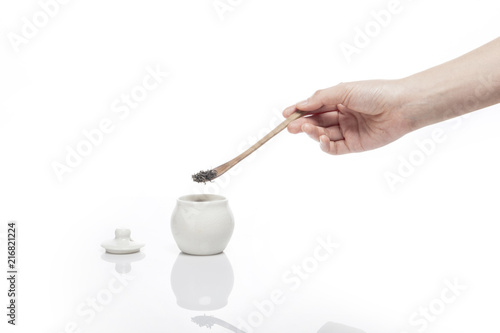 woman hand drop a green tea isolated white.