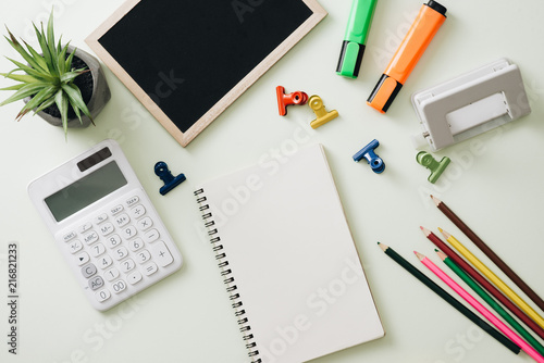 Business concept: stapler,markers, magnifier, cutter, tape, pen, pencil, clip, calculator, calendar and color pencil