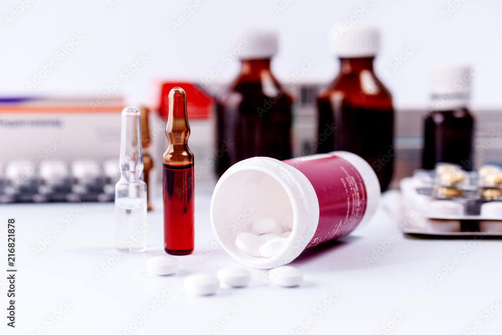 Ampoules and medical preparations on white table Ampoules and medical preparations on white table