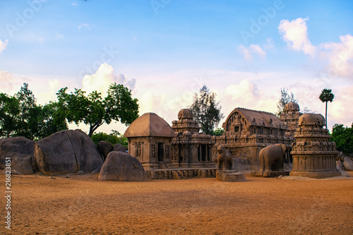 Photo shot on sunrise time where the historical buildings of Mamallapuram monuments are highlighted.  photo