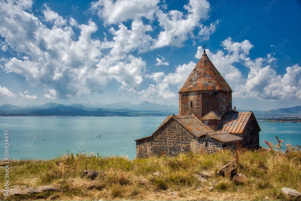 Mountain lake landscape view with clouds and monastery Mountain lake landscape view with clouds and monastery