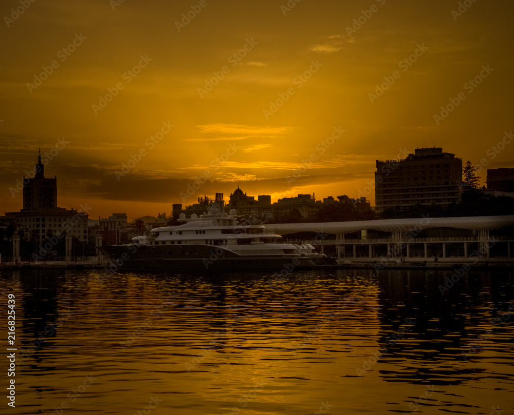 Fototapeta premium Spain, Malaga, a sunset over a body of water